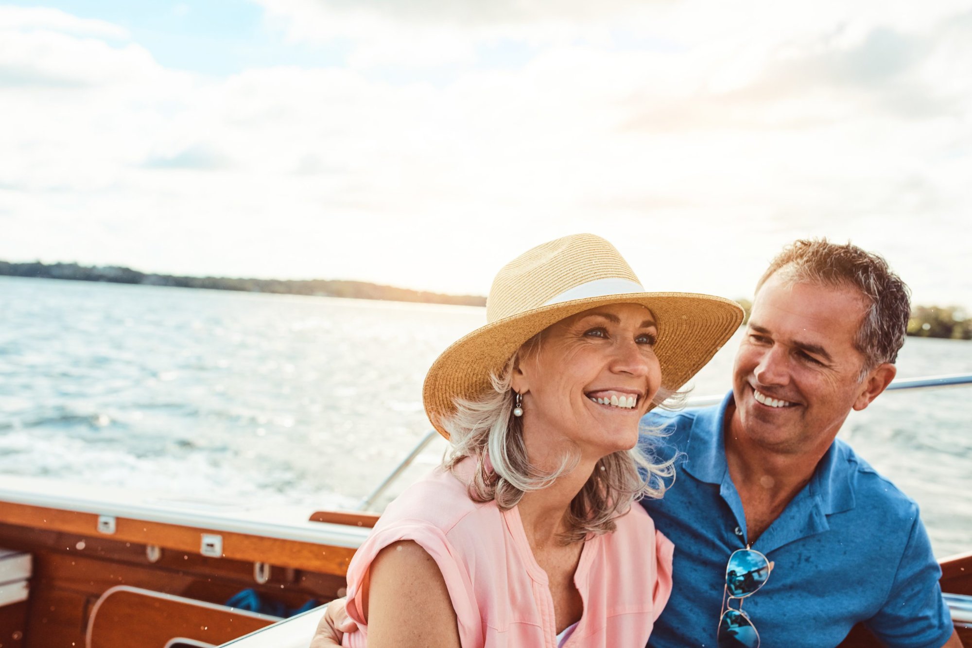 Couple enjoying life on a boat — the freedom of early retirement